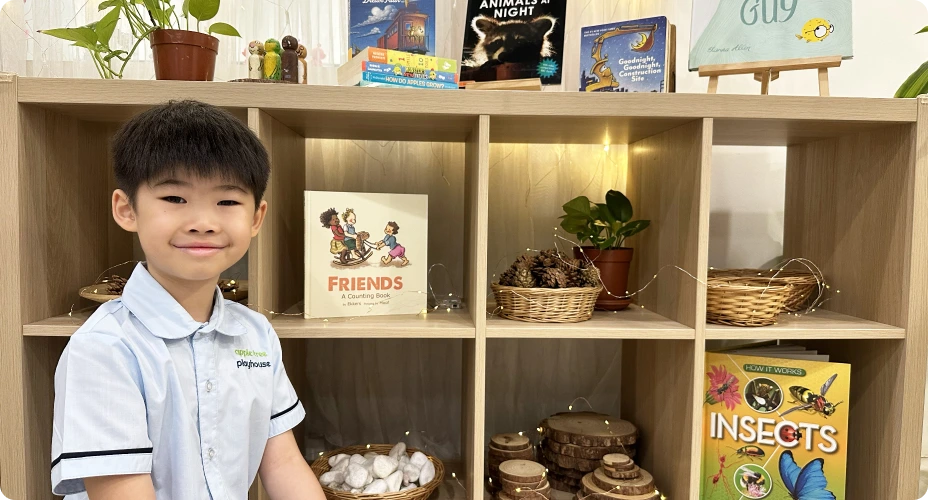 A boy smiling happily at Apple Tree Playhouse nursery in Yishun