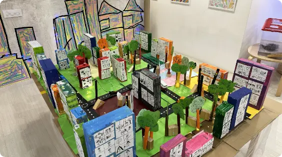 Handmade miniature city model with buildings, roads, and trees at Apple Tree Playhouse childcare in Yishun