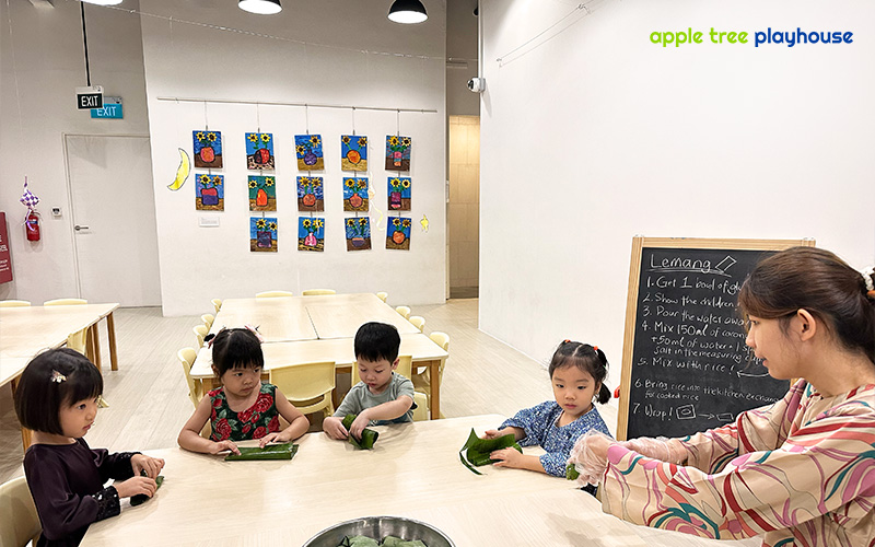 Preschool teacher playing with children 
